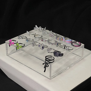 Luxe zircon butterfly and bow open rings displayed on a premium transparent acrylic stand