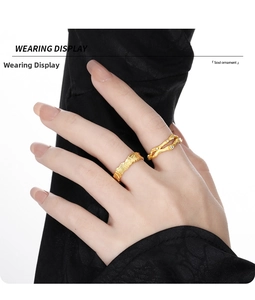 Detail of gold-plated silver rings featuring hammered texture and branch-like cubic zirconia band