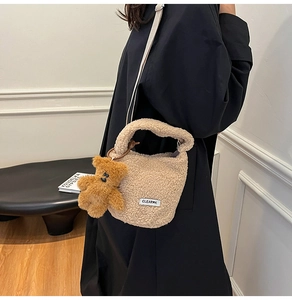 Détail du sac seau beige en molleton avec texture laine d'agneau et pendentif ours