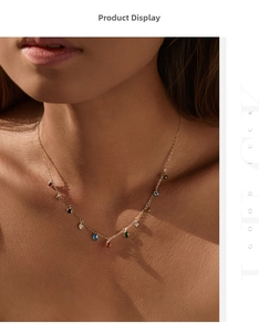 Detailed shot of a gold necklace featuring teardrop-shaped multicolor crystal pendants