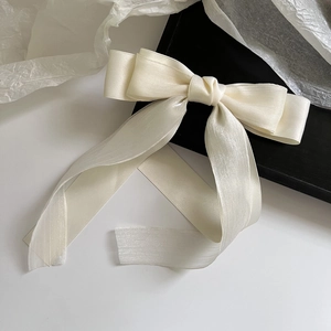 Elegant off-white mesh satin bow hair clip for women displayed on a clean white surface