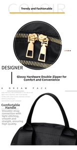 Detail of dual gold metal zippers and reinforced top handle on a black nylon backpack