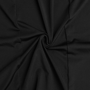 Close-up of high-quality black textile fabric with smooth texture and soft pleats