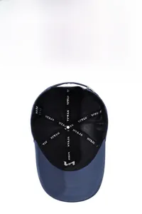 Detailed interior of dark blue baseball cap showing reinforced seams and adjustable metal buckle