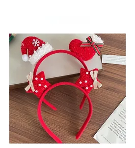 Detail of red plush Christmas headbands with knit santa hat, stars, and snowflakes