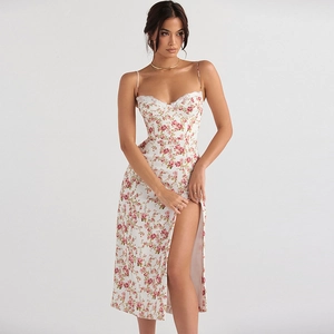 Close-up of white floral sundress featuring red rose patterns and lace-trimmed neckline