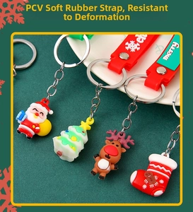 Detail of PVC soft rubber Christmas keychains featuring Santa and reindeer with wrist straps