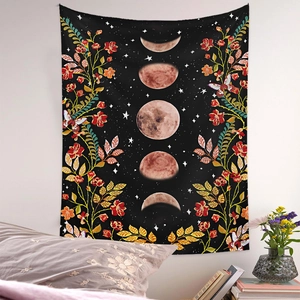 Detail of moon phase tapestry with vibrant floral patterns hanging on a bedroom wall