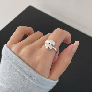 Minimalist 925 sterling silver heart-shaped open ring shown on a finger in a top view