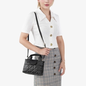 Classic black quilted handbag with adjustable shoulder strap shown on white background