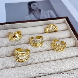 Detailed macro view of five 18K gold-plated mesh rings with cubic zirconia inlay on velvet