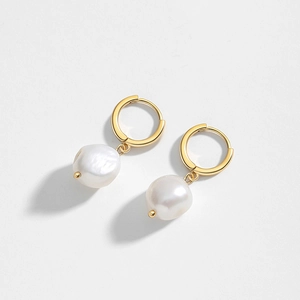 Baroque freshwater pearl earrings with gold-plated metal hoops on white background