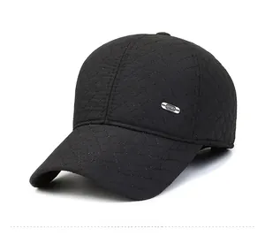 Macro view of men's winter baseball cap with diamond stitching and metal Sport badge
