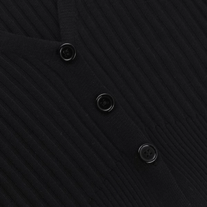 Detailed view of black ribbed knit cardigan featuring three classic four-hole buttons
