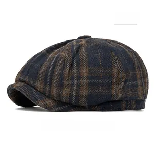 Detail view of the navy plaid wool texture and stitching on the newsboy flat cap
