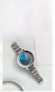 Detail of minimalist stainless steel watch with gradient blue dial and silver link strap