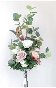 Detailed view of luxury artificial roses in pink and white on a silver metal stand