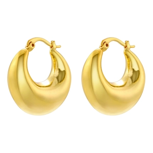 Macro shot of thick gold drop earrings with high-polish mirror finish and leverback closure