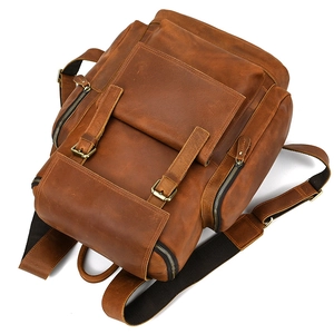 Close-up of vintage brown crazy horse leather backpack with metal buckles and stitching