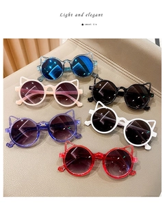 Flat lay of cat ear children's sunglasses in blue, pink, black, purple, white, and red