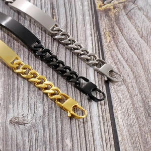 Three Cuban chain bracelets in silver, black, and gold on a wooden surface