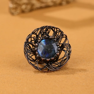 Detailed view of handmade bird nest wire wrapped ring with blue fire labradorite stone