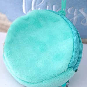 Minimalist round plush mint green coin purse with shoulder strap in top view