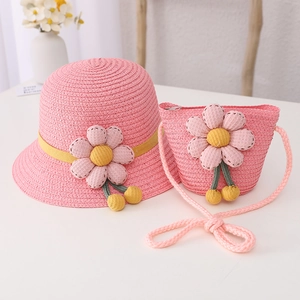 Detailed close-up of pink straw hat and matching bag with 3D floral decorations
