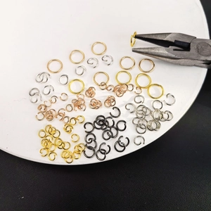 Macro view of multi-colored copper jump rings for jewelry making with pliers