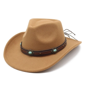 Close-up of camel felt cowboy hat with brown leather band and turquoise bead detailing