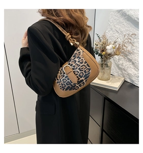 Detail of leopard print underarm bag with metal buckle and knotted shoulder strap