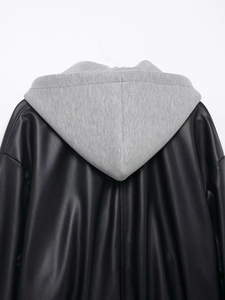 Back view detail of black faux leather jacket with grey knit hood and stitched textures