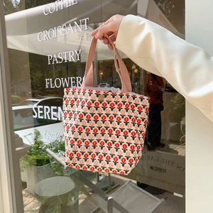 Detailed close-up of tulip print corduroy tote bag with pink straps and metal snap button