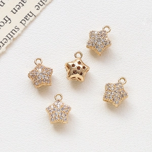 Macro detail of gold-plated star pendants with cubic zirconia for jewelry making