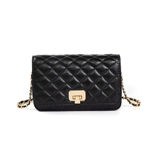 Classic black quilted crossbody bag with golden chain strap and swivel lock on white background