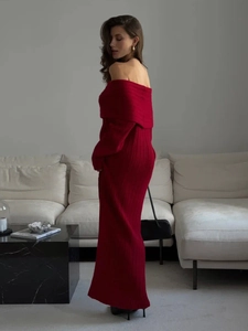 Detail of red off-shoulder knitted dress showing ribbed texture and fold-over neckline