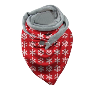 Detail of red Christmas scarf with snowflake patterns, button closure and gray lining