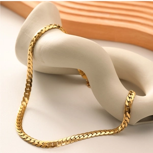 Close-up of a 18k gold plated stainless steel flat snake chain on a decorative stand