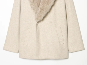Detail of a beige coat featuring a faux fur collar and double-breasted fabric buttons