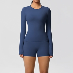 Detail of dark blue high-stretch yoga set with long sleeve top and athletic shorts