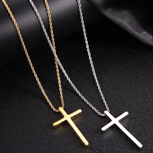 Close-up of gold and silver stainless steel cross pendants with twisted rope chains