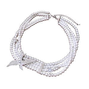 Multilayer pearl necklace with swallow pendant and sun charm on white background