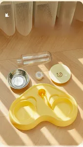 Close-up of dual pet feeder parts with stainless steel bowl and auto water bottle