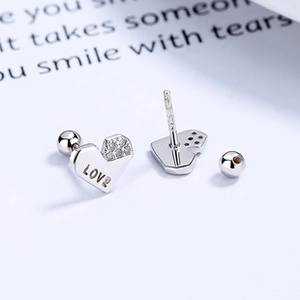 Detail of 925 sterling silver heart earrings with LOVE engraving and small zircon stone