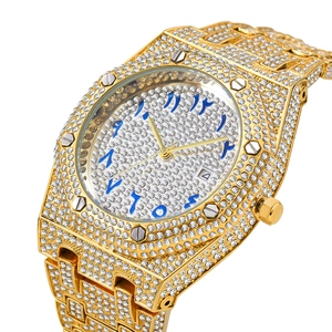Close-up of gold-plated iced-out watch featuring blue Arabic numerals and luxury diamonds