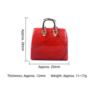 Miniature red gemstone handbag pendant with gold handle and natural stone texture