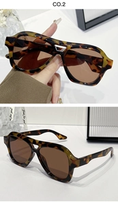 Close-up of tortoise shell aviator sunglasses with thick frames and dark brown lenses