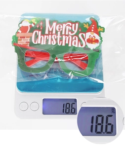 Lightweight Christmas party glasses weighing approximately 18.6g on a digital scale