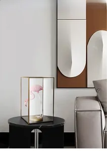 Detailed view of pink flamingo sculpture in a gold metal frame glass display box
