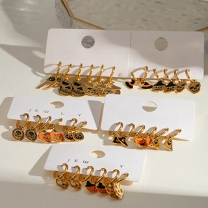 Halloween pumpkin and skull earrings set in gold finish on jewelry card display